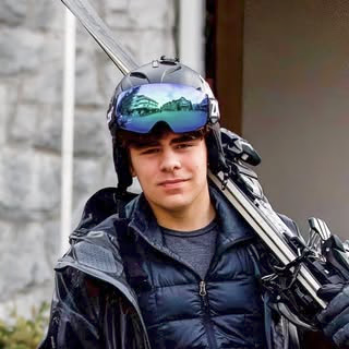 Chase carrying his skis